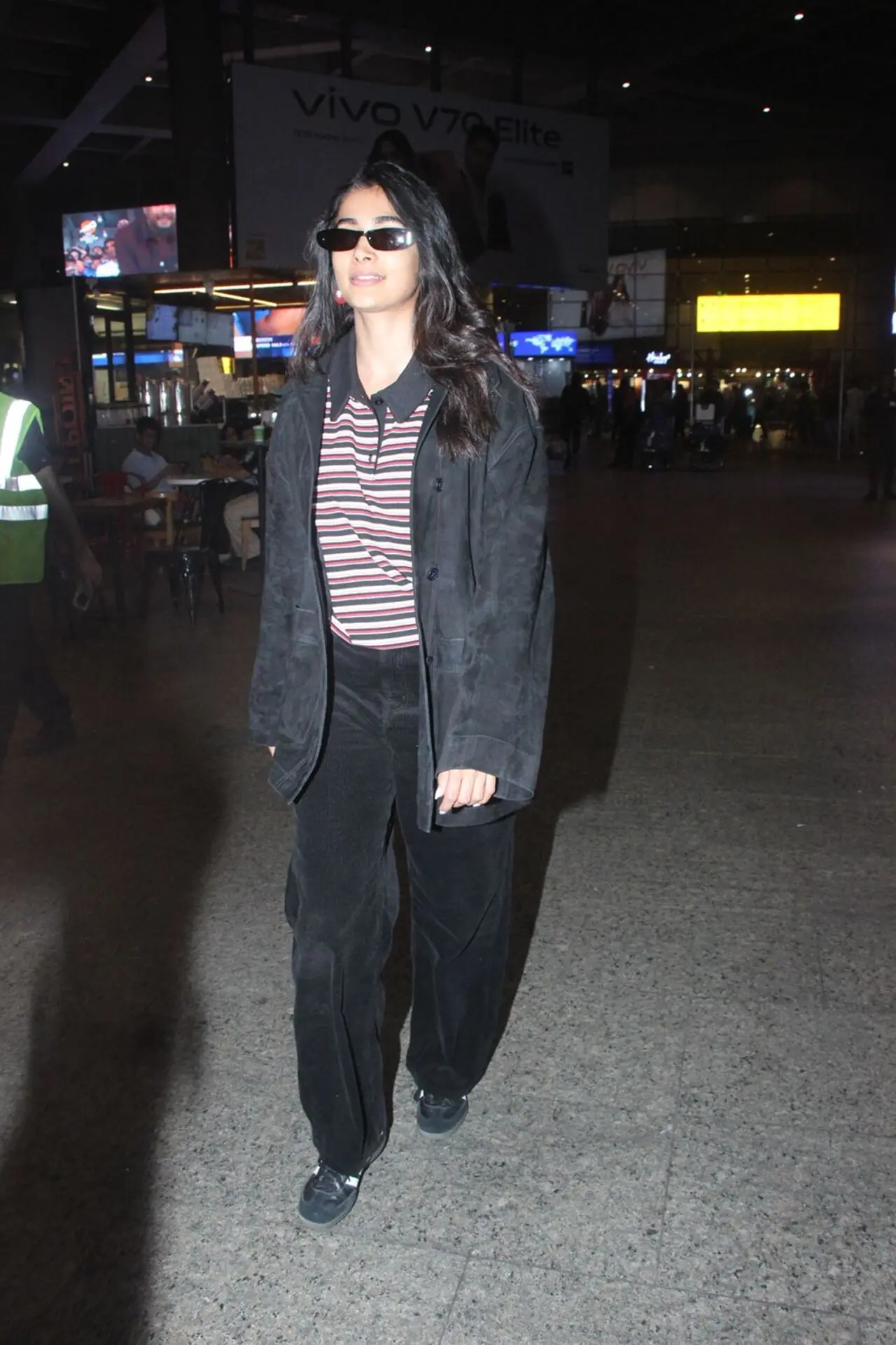 Pooja Hegde was spotted at the airport earlier on Tuesday as she arrived in the city in a stripped t-shirt, trousers and an oversized jacket.
